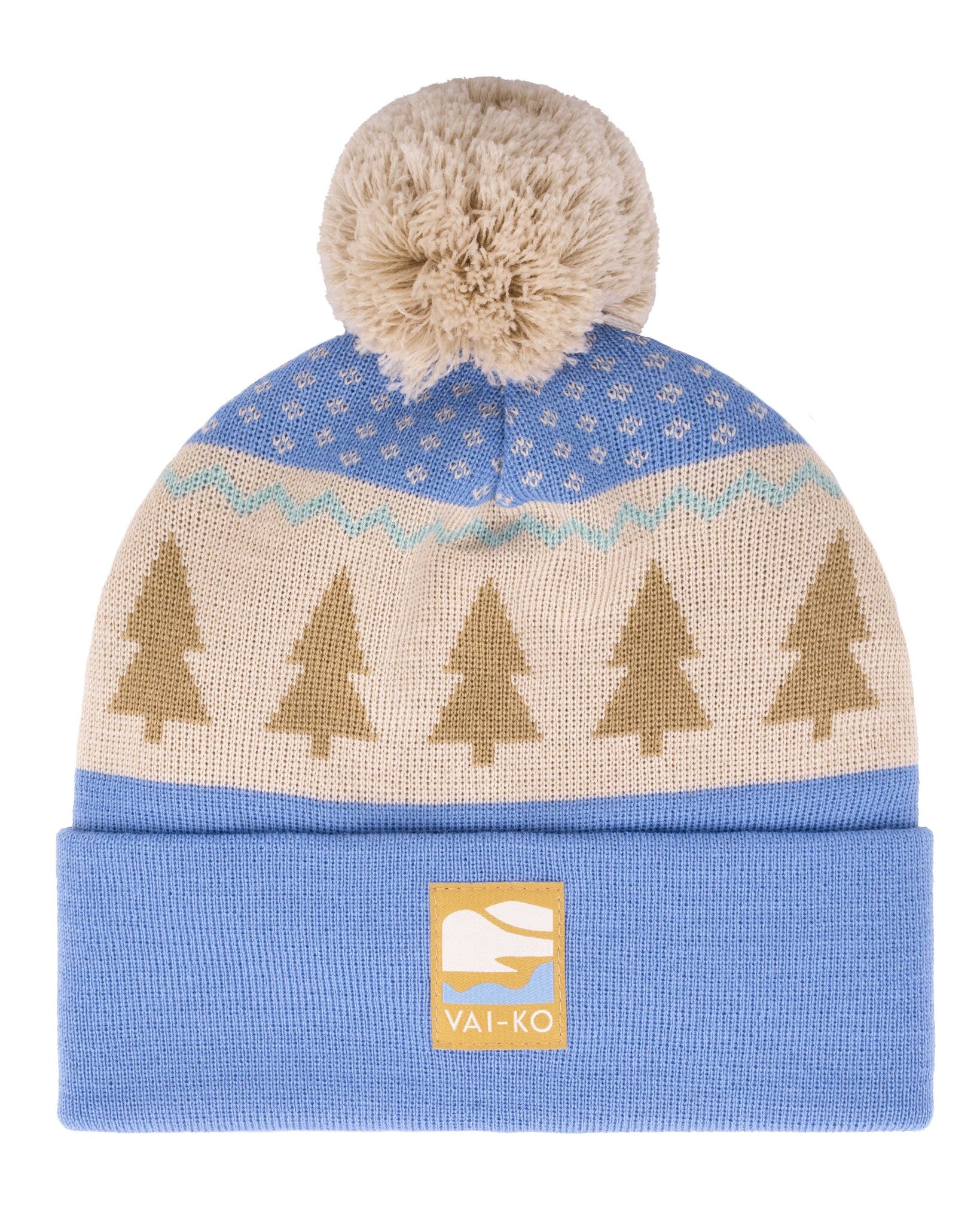 Blue knit beanie with a beige pattern of trees, a pom-pom on top, and a VAI-KO label on the cuff.