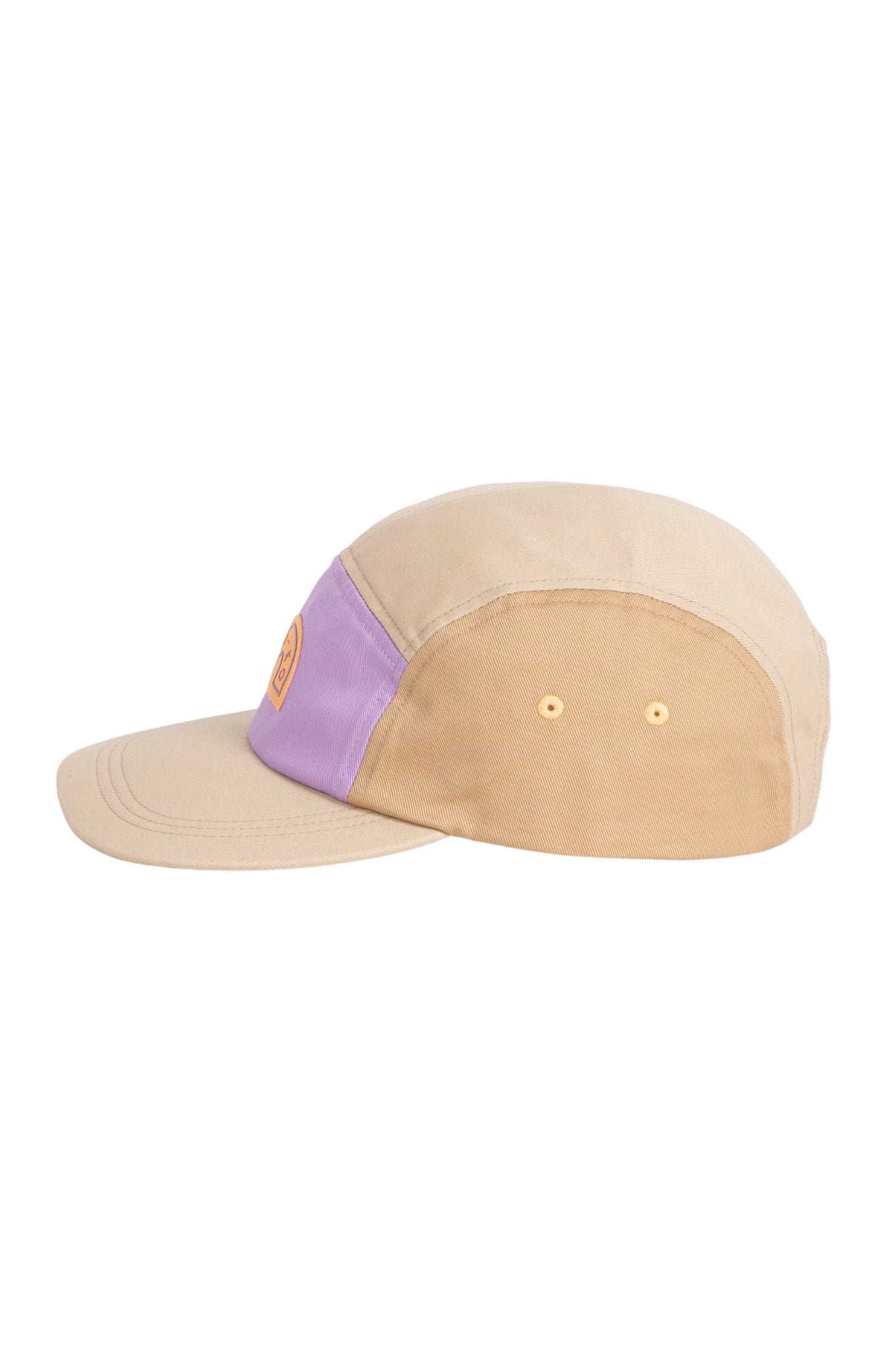Beige and light purple five-panel cap with a round yellow logo on the front, shown from the side.