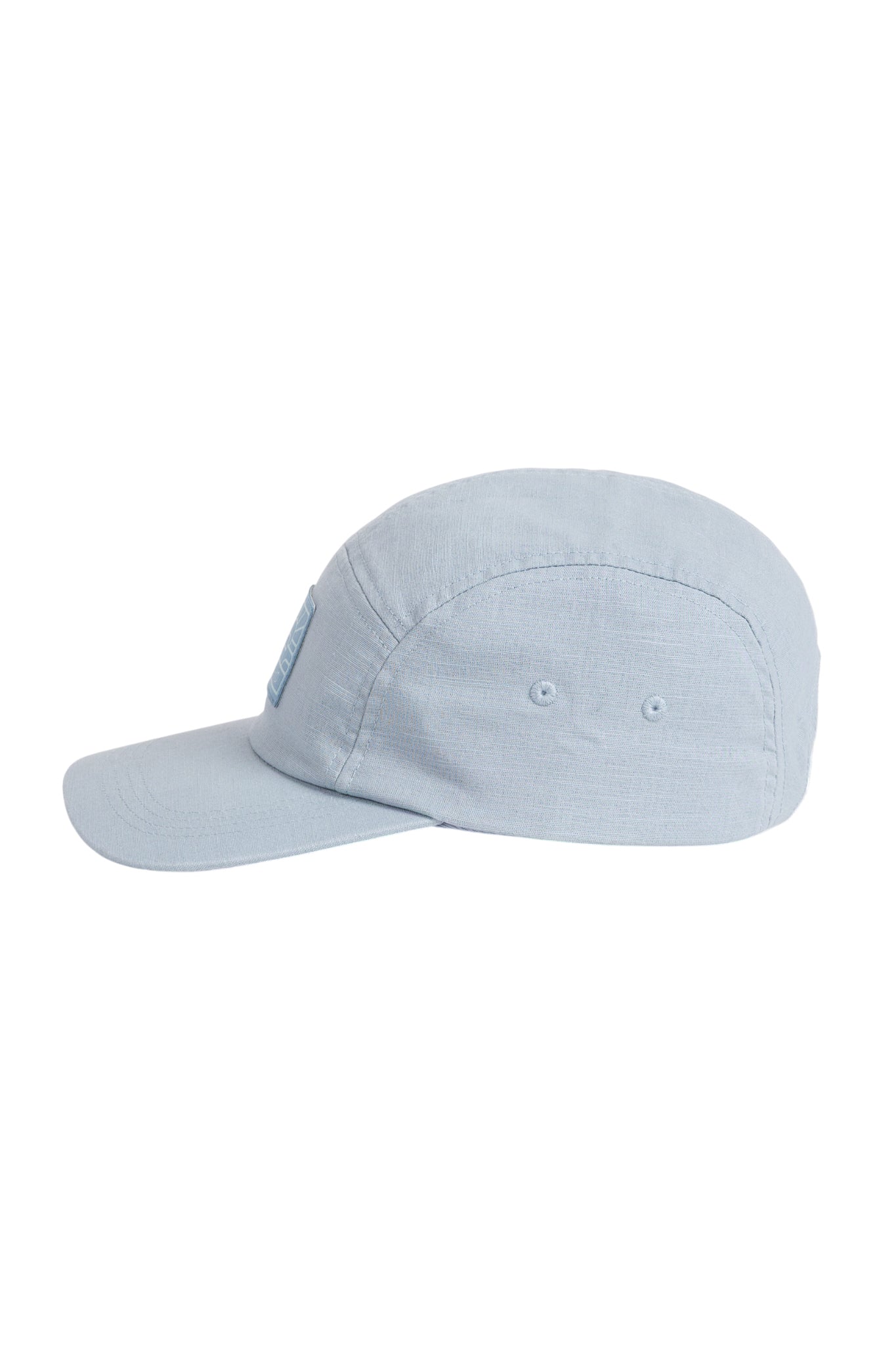 Light blue baseball cap shown from the side, with two small ventilation holes and a curved brim.