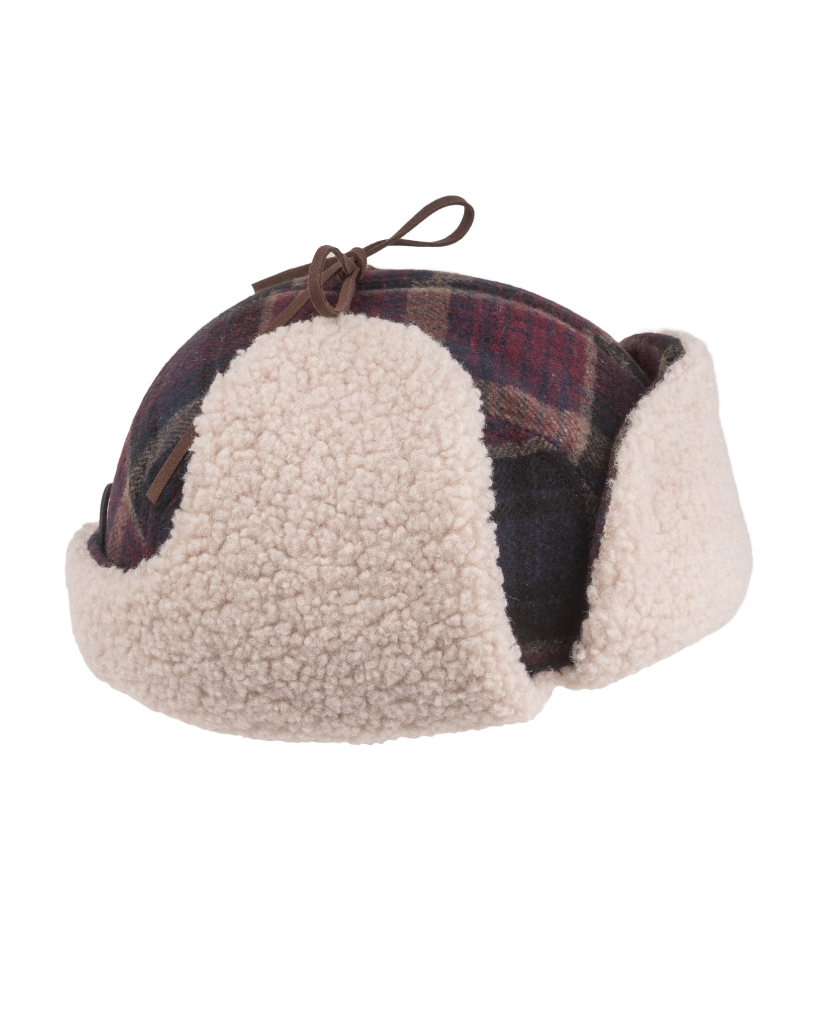 Plaid and sherpa winter hat with ear flaps and a string tie on top, isolated on a white background.