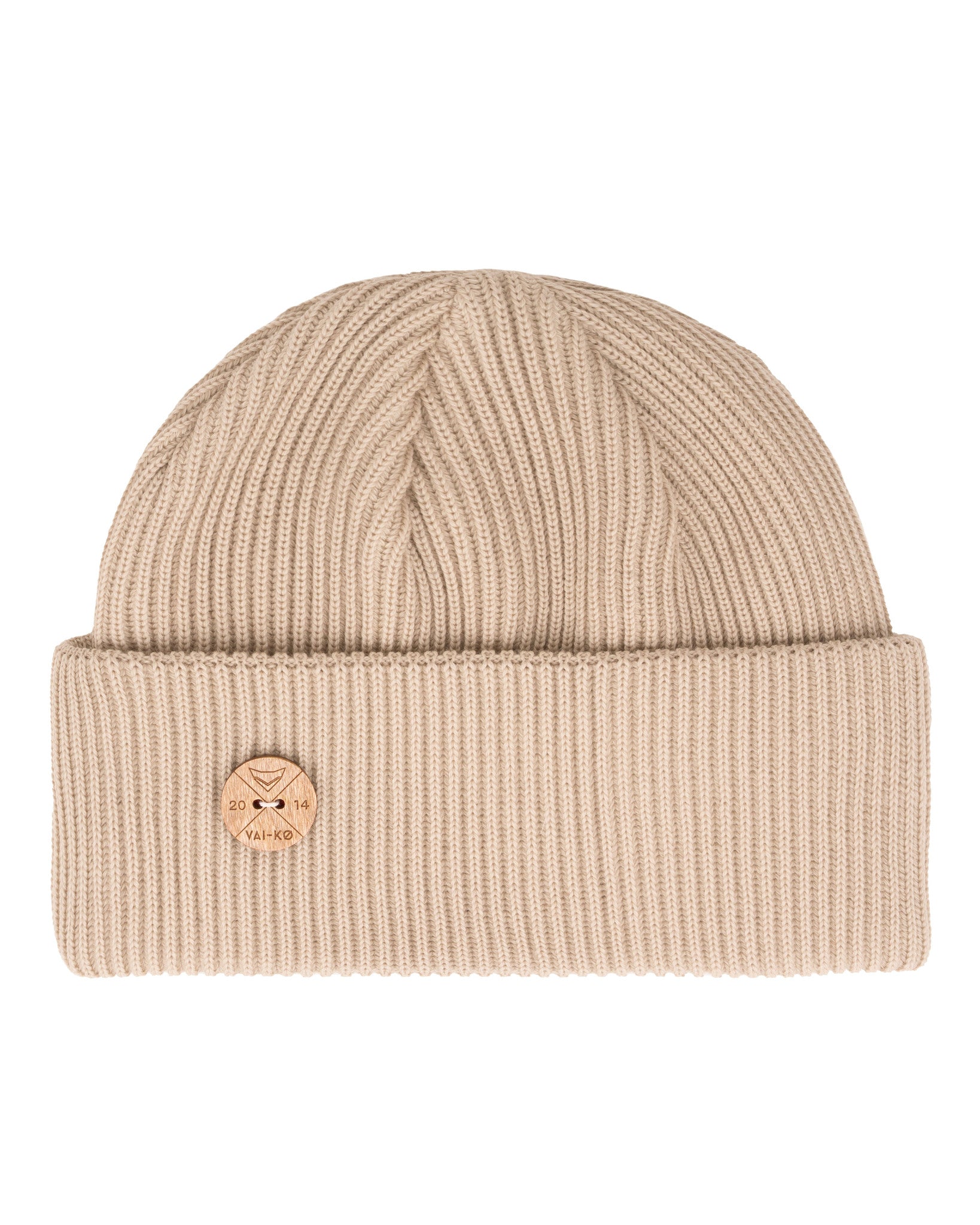 Beige ribbed knit beanie with a folded brim and a round wooden logo pin on the front.